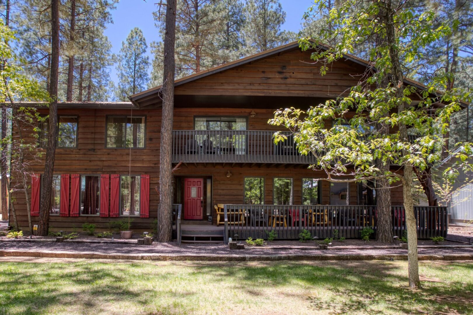 A large wooden house with many windows and doors.